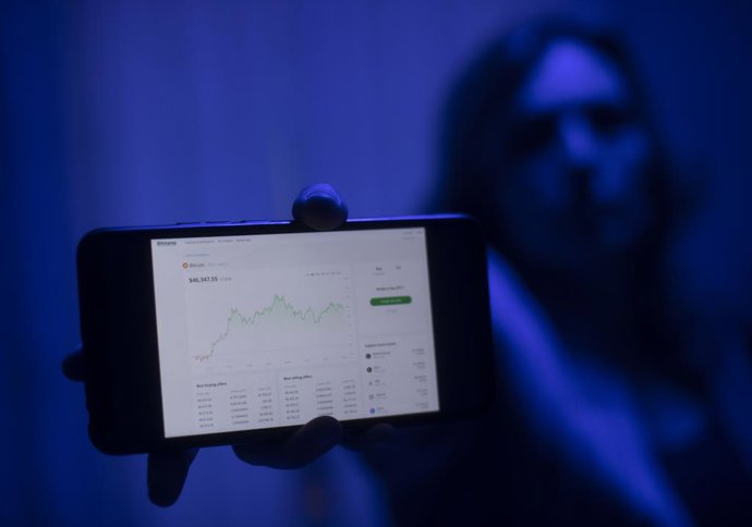 Archivo - Una internauta utiliza una web para invertir en criptomonedas, en Madrid (España), a 9 de febrero de 2021.
