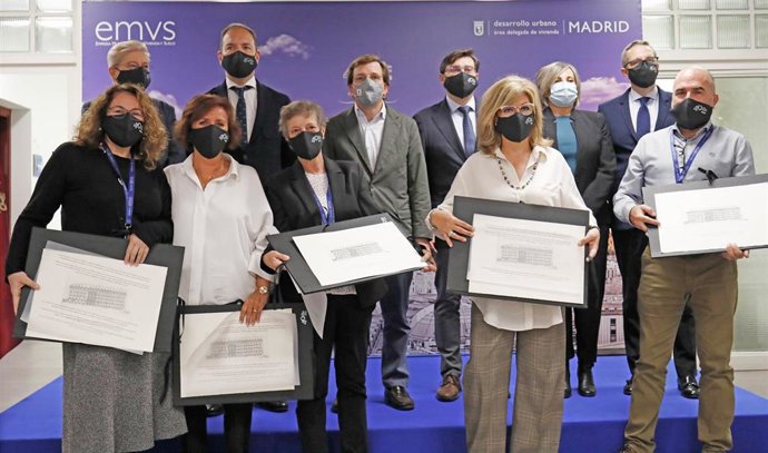 El alcalde de Madrid, José Luis Martínez-Almeida (c), posa con algunos de los trabajadores más antiguos de la EMVS durante su visita a la sede de la Empresa Municipal de la Vivienda y Suelo (EMVS).