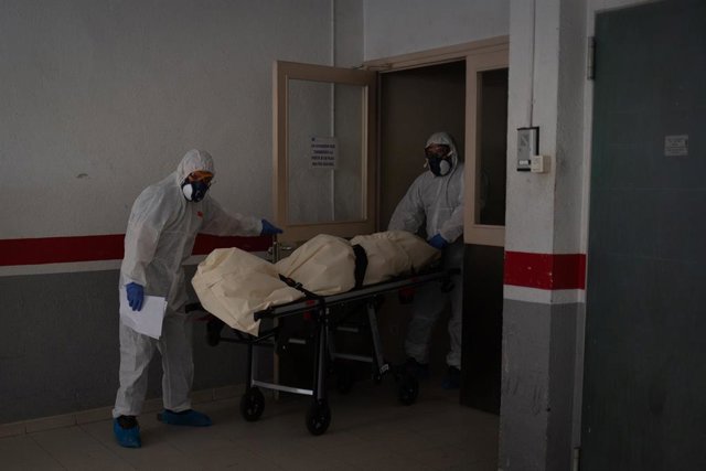 Archivo - Varios operarios protegidos de los Servicios Funerarios Memora trasladan un cuerpo de una residencia  en el garaje de una residencia de ancianos para recoger el cuerpo de una persona fallecida con Covid-19
