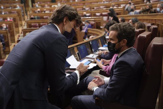 El vicesecretario de Comunicación del PP, Pablo Montesinos (i), conversa con el líder del PP, Pablo Casado, en una sesión de control al Gobierno en el Congreso de los Diputados, a 13 de octubre de 2021, en Madrid, (España). Durante la sesión, el Ejecutivo