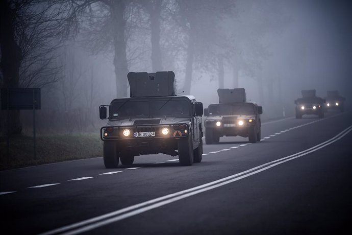 11 November 2021, Poland, Kuznica: Humvees of the Polish Army are on their way to the Kuznica border crossing on the border between Poland and Belarus. The migration crisis involving refugees trying to enter the European Union via Belarus has escalated 