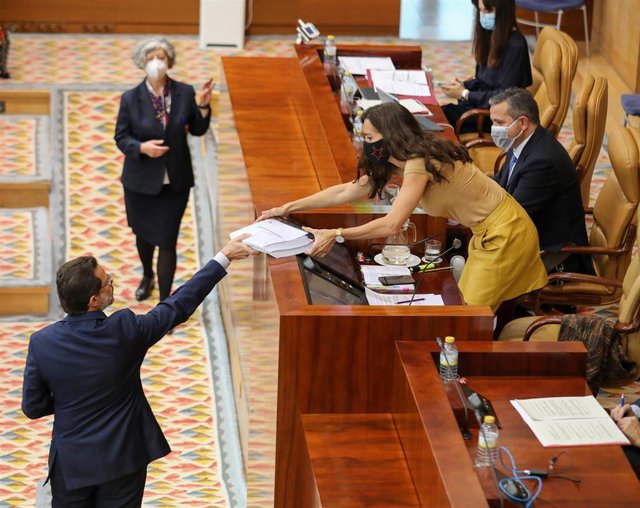 El consejero de Hacienda, Javier Fernández-Lasquetty entrega a la presidenta de la Asamblea de Madrid , Eugenia Carballedo copias de contrataciones de emergencia en la región por la crisis del Covid-19