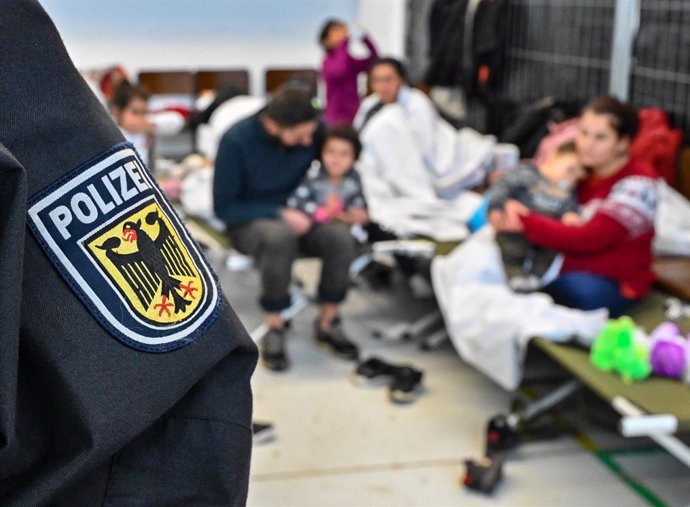 05 November 2021, Brandenburg, Frankfurt_Oder: Migrants sit at the new central processing centre of the Federal Police and the Federal Office for Migration and Refugees (BAMF). On average more than 100 illegal migrants are reaching Germany every day aft