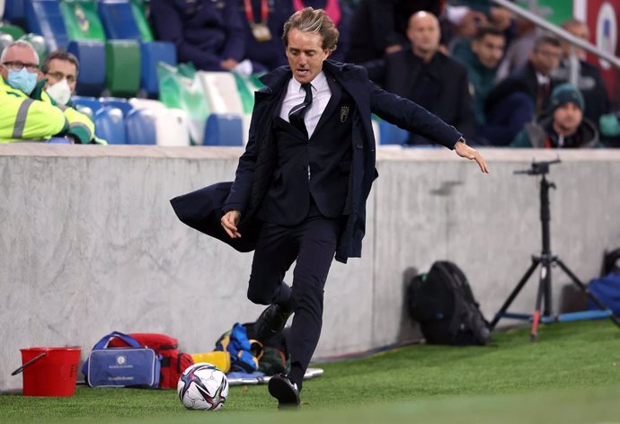 15 November 2021, United Kingdom, Belfast: Italy manager Roberto Mancini races to collect the ball as it goes out of play during the 2022 FIFA World Cup European qualifiers Group C soccer match between Northern Ireland and Italy at Windsor Park Stadium.
