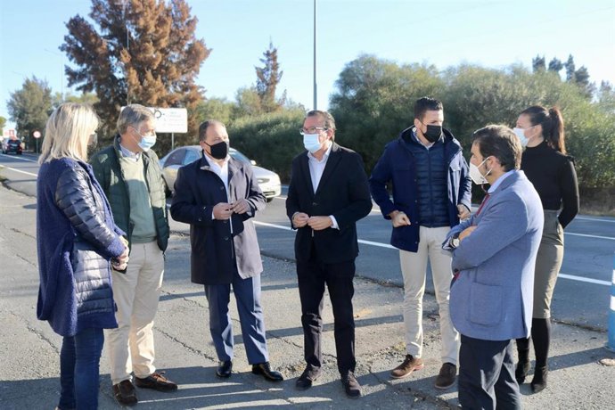 El presidente del PP de Huelva, Manuel Andrés González, junto al alcalde de Aljaraque, David Toscano, y otros responsables populares, en el cruce A-5077 con A-492.