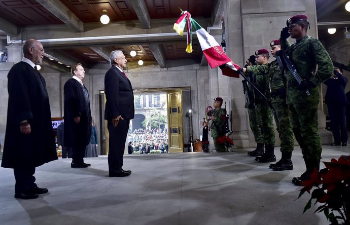 Archivo - 11 December 2019, Mexico, Mexico City: Mexican President Andres Manuel Lopez Obrador (C) salutes the national flag, while arriving to attend the first report of the President of the Supreme Court of Justice of the Nation Arturo Zaldivar Lelo d