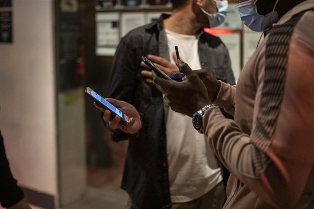 Archivo - Una persona muestra un código QR para entrar a un local de ocio nocturno la misma noche en que entra en vigor la reapertura en interiores a medianoche, a 8 de octubre de 2021, en Barcelona, Cataluña (España).