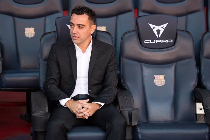 Xavi Hernandez poses for photo on the bend during his presentation as new head coach of FC Barcelona at Camp Nou stadium on November 08, 2021, in Barcelona, Spain.