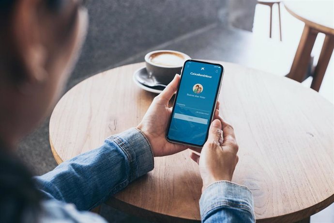 Cell phone mockup image blank white screen.Woman hand holding texting using mobile on desk at coffee shop.Background empty space for advertise.Work people contact marketing business,technology