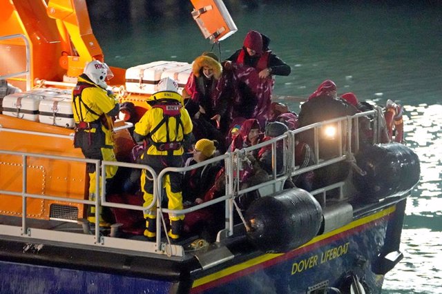 25 November 2021, United Kingdom, Dover: A group of people thought to be migrants are brought into Dover, Kent, by the RNLI, following a small boat incident in the Channel. 27 migrants died yesterday after their boat capsized in the English Channel, the F