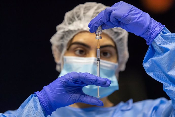A health care worker fills a syringe with Pfizer vaccine at the COVID-19 mass vaccination clinic at the Perth Convention and Exhibition Centre in Perth, Monday, November 15, 2021. WA remains closed to NSW, Victoria and the ACT and based on the pace of i