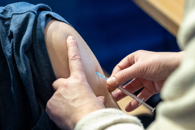 18 November 2021, Bavaria, Nuernberg: A man receives his second dose of the Pfizer-BioNTech coronavirus vaccine at a vaccination center. Photo: Daniel Karmann/dpa