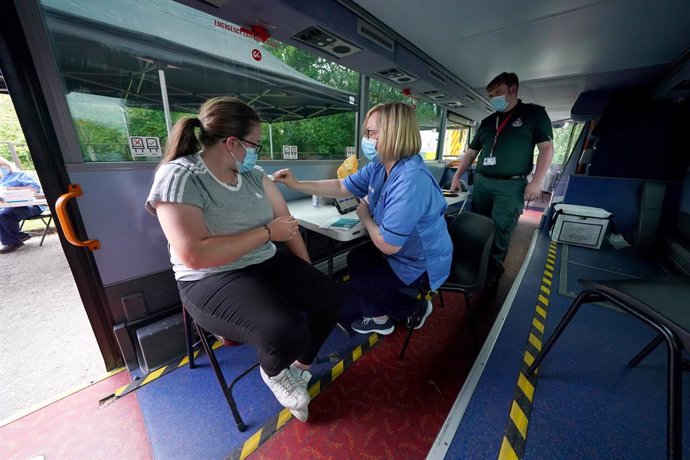 Archivo - 02 July 2021, United Kingdom, Crieff: Vaccination Nurse Lesley Cousland gives a vaccination to a member of the public onboard a bus in the car park of Crieff Community Hospital. The bus is being used by the Scottish Ambulance Service as a mobi
