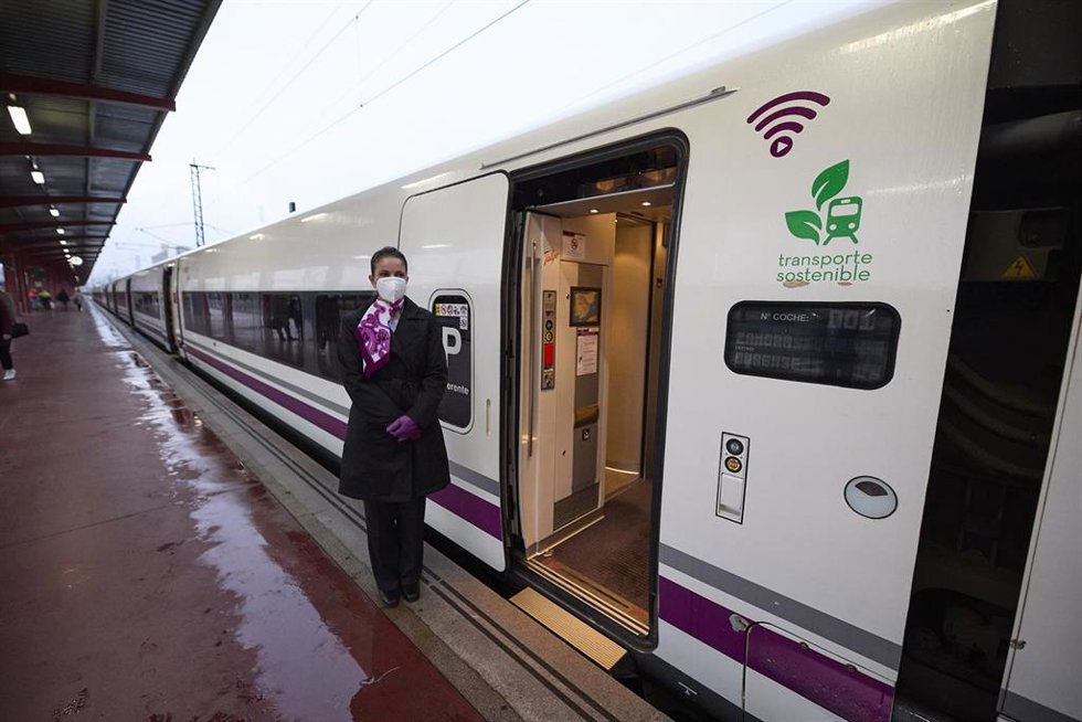 Una azafata en las puertas de un tren de alta velocidad.