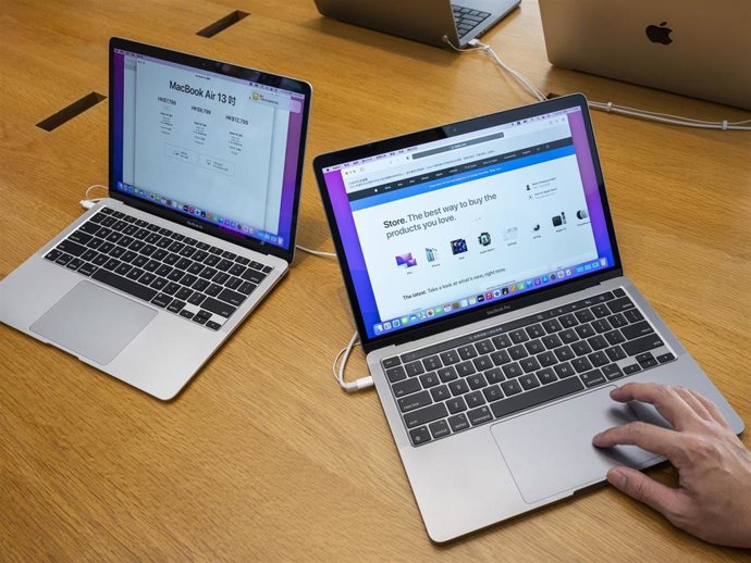 A shopper is seen using a Macbook Pro computer at an Apple store