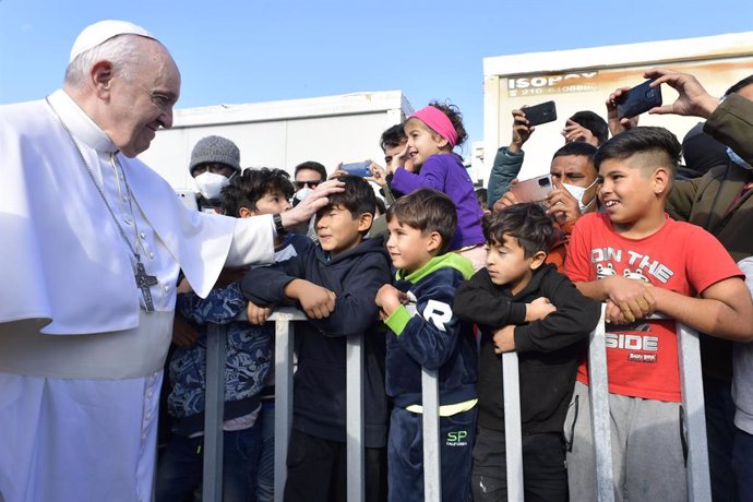 05 December 2021, Greece, Lesbos: Pope Francis (L)greets refugees during his visit to the Reception and Identification Centre (RIC) in Mitilini on the island of Lesbos in Greece. Pope Francis is returning to the island of Lesbos, the migration hotspot 