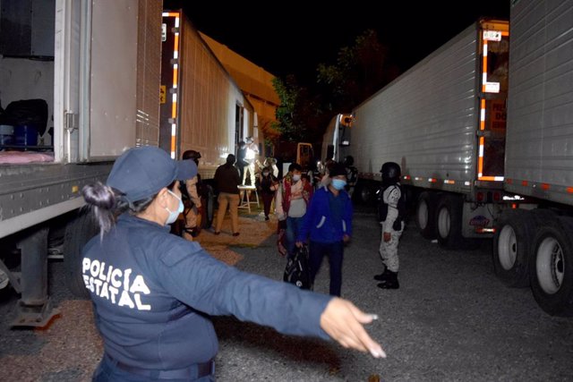 Archivo - HANDOUT - 08 October 2021, Mexico, Hidalgo: Police and officials help migrants out of a truck. Soldiers in Mexico discovered a total of 652 Central American migrants hiding in three sealed refrigerated cargo trucks, the country's INM immigration