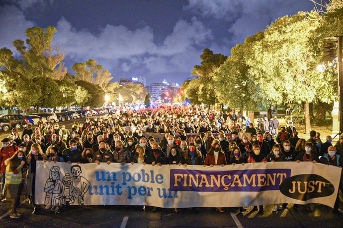 Diverses persones sostenen una pancarta on es llig "Un poble unit per un finanament just", durant la manifestació del 20N pel finanament