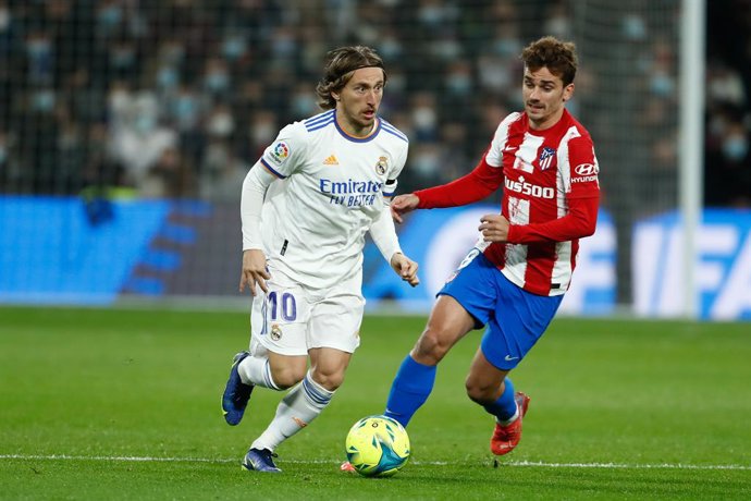 Luka Modric of Real Madrid and Antoine Griezmann of Atletico de Madrid in action during the spanish league, La Liga Santander, football match played between Real Madrid and Atletico de Madrid at Santiago Bernabeu stadium on December 12, 2021, in Madrid,