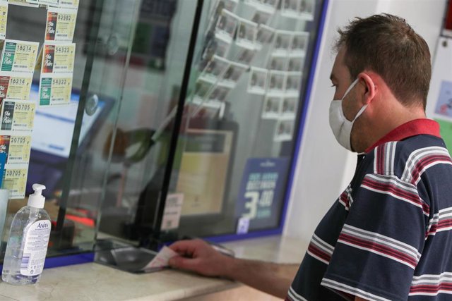 Archivo - Un hombre compra lotería.