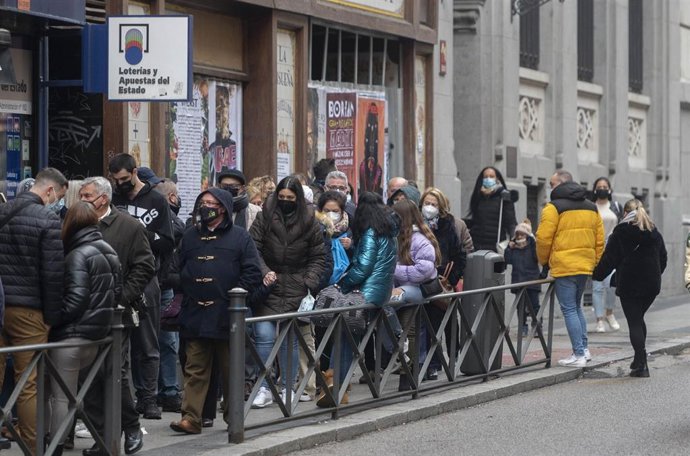 Varias personas hacen cola en una administración de Loterías del centro de Madrid cuando quedan menos de tres semanas para el Sorteo Extraordinario de la Lotería de Navidad, a 7 de diciembre de 2021, en Madrid (España). Como cada año, la Lotería de Navi