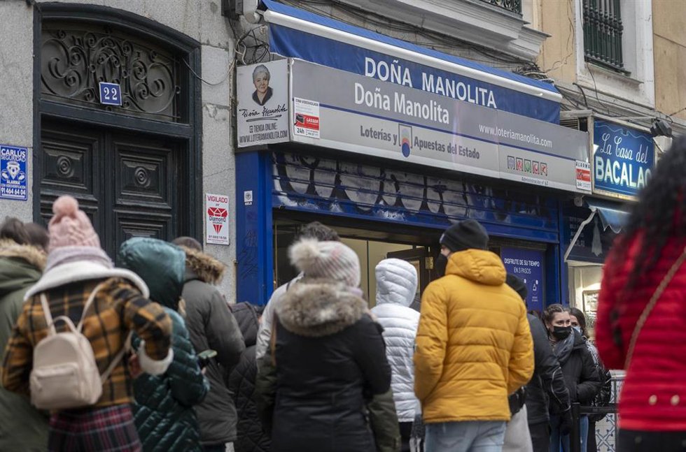 Varias personas hacen cola en la Administración de Loterías 'Doña Manolita' cuando quedan menos de tres semanas para el Sorteo Extraordinario de la Lotería de Navidad, a 7 de diciembre de 2021, en Madrid (España). Como cada año, la Lotería de Navidad se