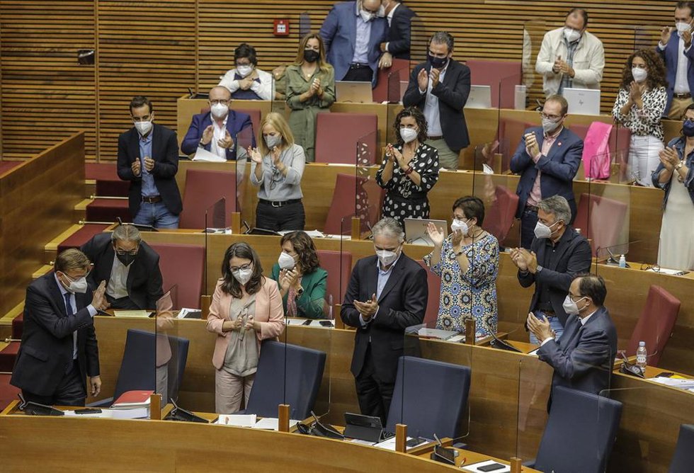 Archivo - El 'president' de la Generalitat, Ximo Puig (1i), saluda durante un pleno de las Cortes valencianas en el Palau de las Cortes Valencianas