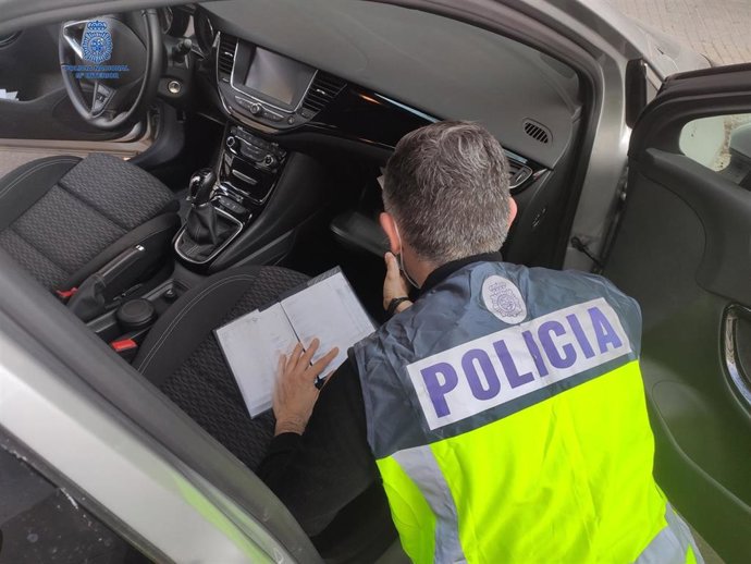 Un agente de la Policía Nacional, con uno de los cohes que vendía el grupo criminal en Palma.