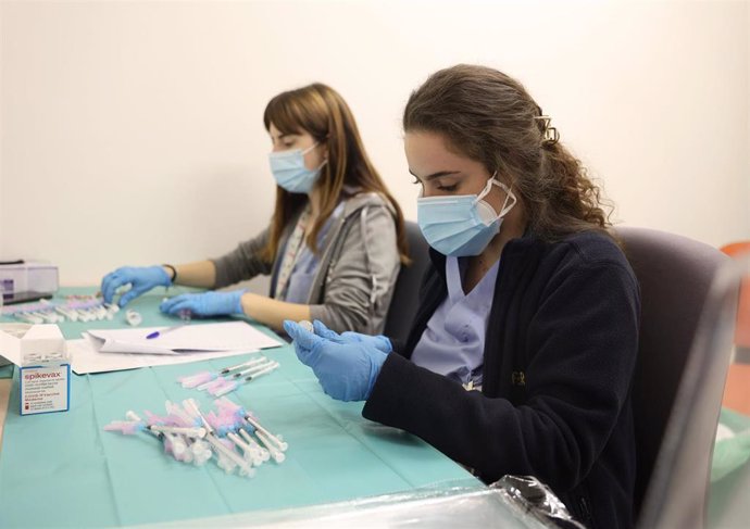 Dos enfermeras preparan una vacuna contra el Covid-19, en el Hospital Infanta Sofía, a 30 de diciembre de 2021, en San Sebastián de los Reyes, Madrid, (España). La Comunidad de Madrid permite desde hoy inocular la vacuna contra el COVID-19 a los adultos