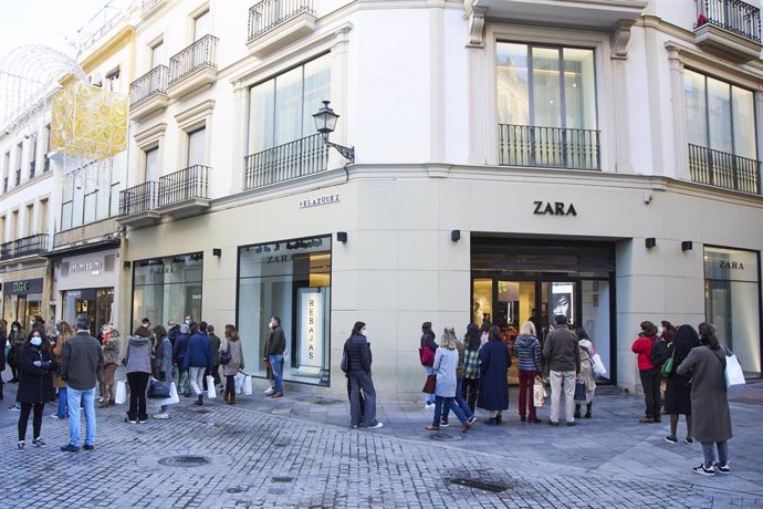 Decenas de personas esperan la apertura de los negocios durante el primer día de las rebajas, a 7 de enero de 2022 en Sevilla.
