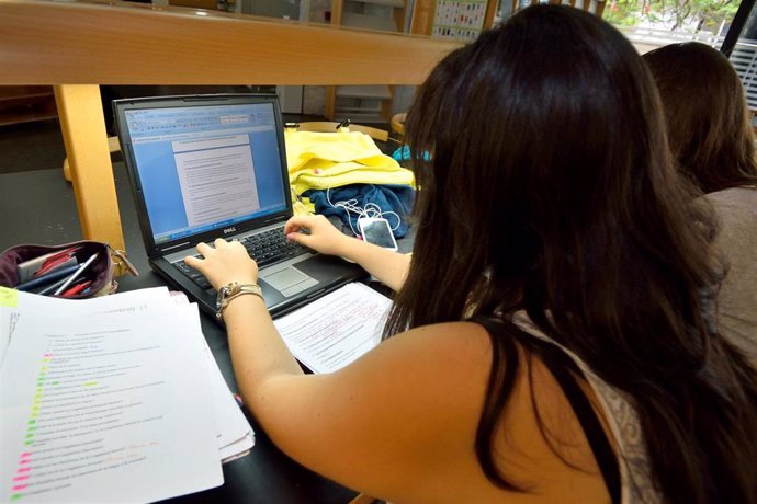 Archivo - Una estudiante con un ordenador portátil