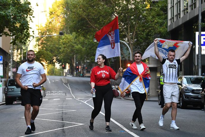Supporters of Serbian tennis player Novak Djokovic arrive to the office of Novak Djokovic's lawyer Nick Wood SC in Melbourne, Monday, January 10, 2022. Novak Djokovic will be freed from immigration detention after an order by the Federal Circuit Court. 