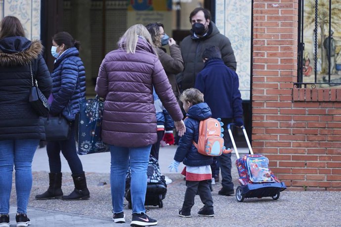 Una madre deja a su hijo en la puerta del colegio tras las vacaciones de Navidad con la aplicación de las nuevas restricciones dependiente de cada comunidad autónoma, a 10 de enero de 2022 en Sevilla (Andalucía, España)