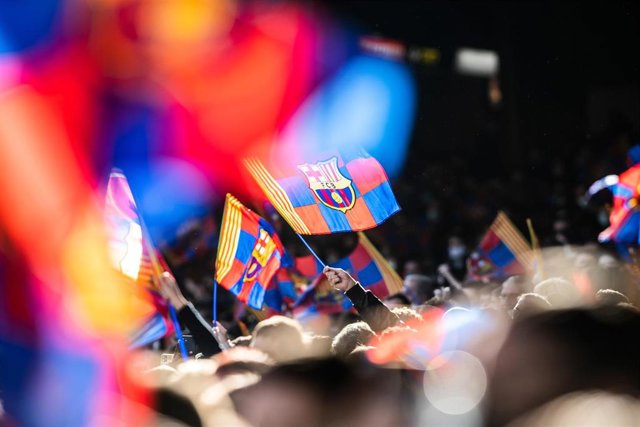 FC Barcelona fans with flags are seen during the training session of the team at Camp Nou Stadium on January 3, 2022 in Barcelona, Spain.