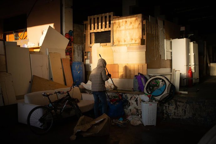 Un home recull els seus estris durant el desallotjament de la nau industrial a Badalona