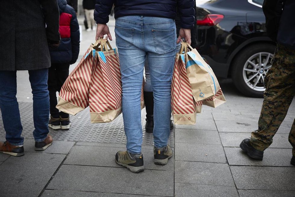Una persona con bolsas en una calle comercial, a 2 de enero de 2022, en Madrid, (España)