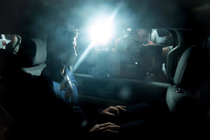 Serbian tennis player Novak Djokovic (centre) departs from the Park Hotel government detention facility before attending a court hearing at his lawyers office in Melbourne, Sunday, January 16, 2022. Novak Djokovic still faces uncertainty as to whether h