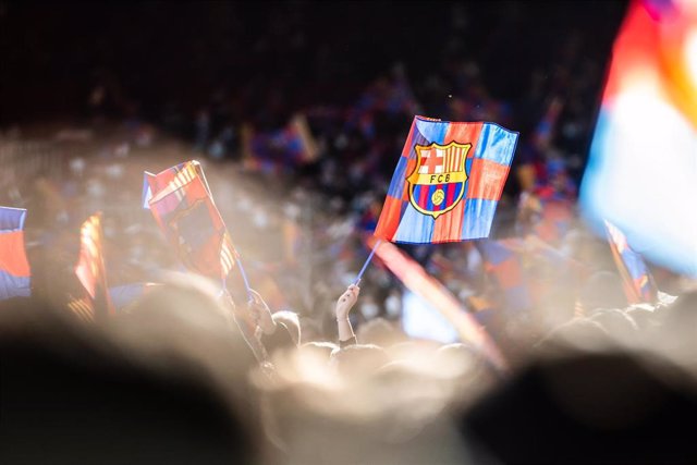 FC Barcelona fans with flags are seen during the training session of the team at Camp Nou Stadium on January 3, 2022 in Barcelona, Spain.