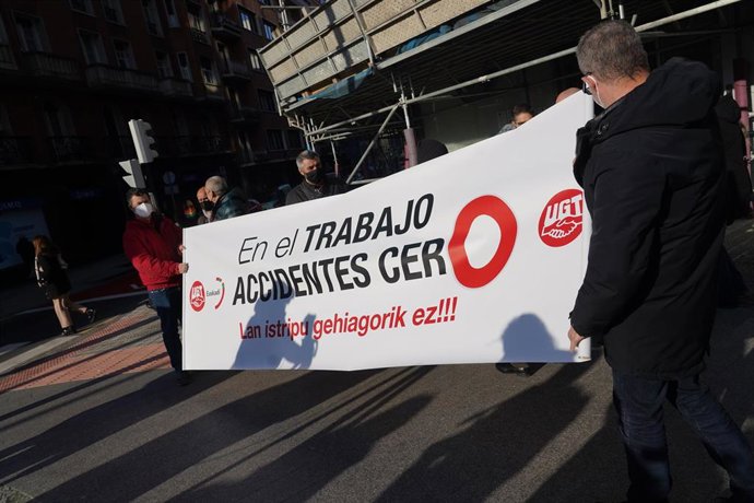Varias personas, con la pancarta que reza  'En el trabajo accidentes cero, en la manifestación por la muerte de un trabajador, en Bilbao, a 27 de enero de 2022, en Bilbao