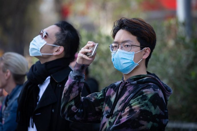 Archivo - Un joven de rasgos asiáticos realiza fotografías.