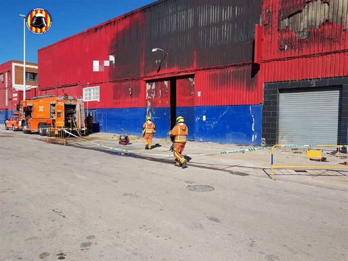 Bomberos continúan trabajando en un almacén de productos de bazar en Manises un día después del incendio