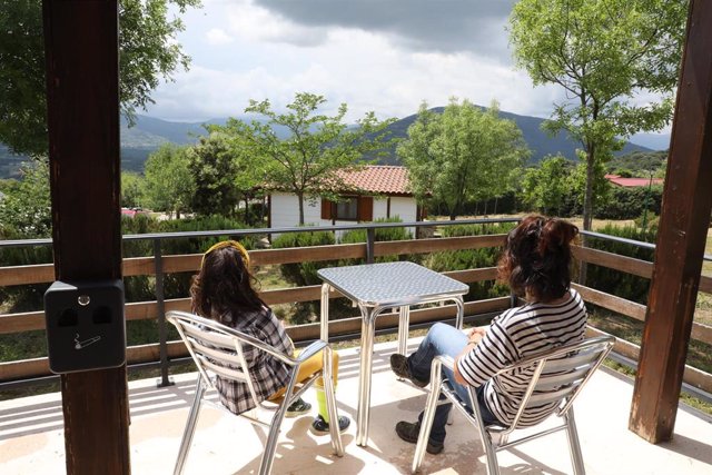 Archivo - Una mujer y su hija disfrutan en el porche de un bungalow del Camping Monte Holiday en Gargantilla del Lozoya