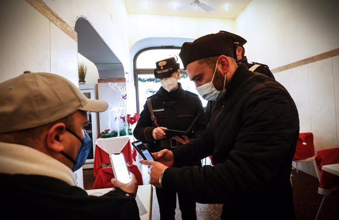 Archivo - 30 November 2021, Italy, Rome: Police officers check the Coronavirus green pass certification for a man in a coffee bar. Photo: Giuseppe Lami/ANSA via ZUMA Press/dpa