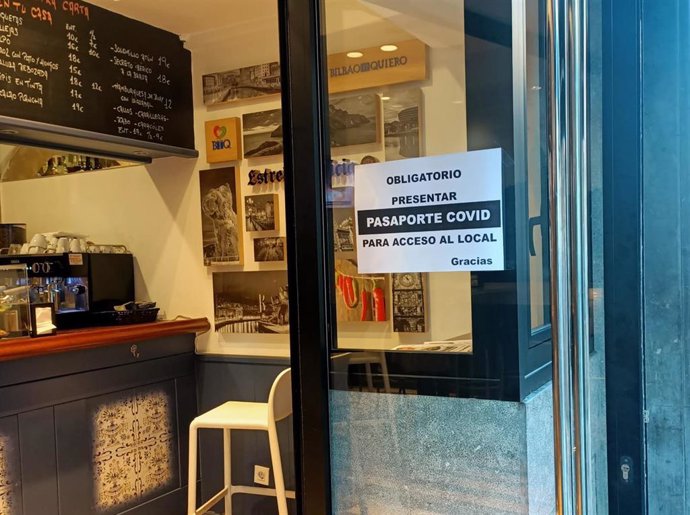 Archivo - Un establecimiento de Bilbao exhibe un cartel con la exigencia de pasaporte covid