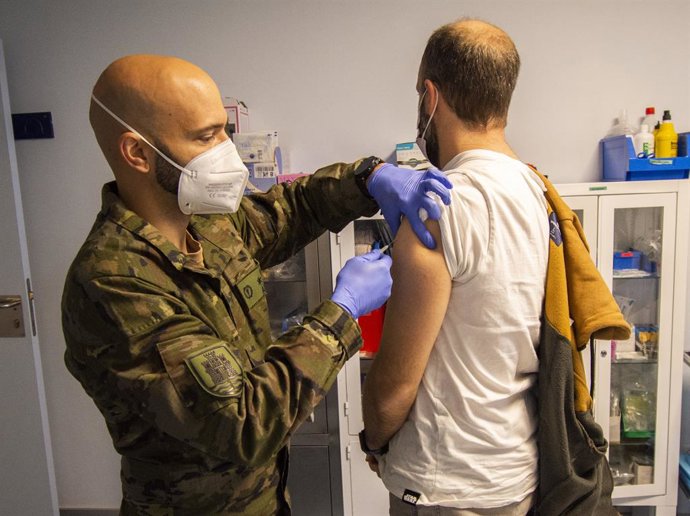 Un militar de la BRI X posa a un home una vacuna contra el Covid-19.