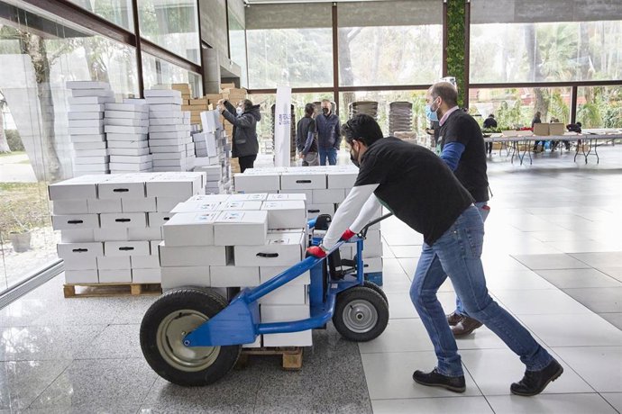 Archivo - Voluntarios recogen menús y  cestas de Navidad.