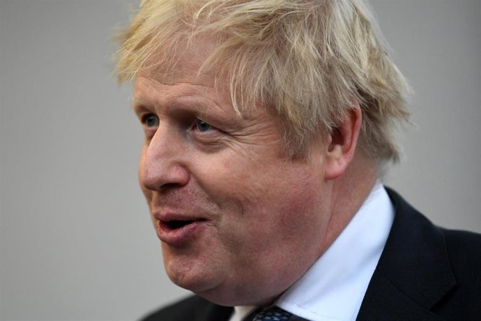 10 February 2022, Poland, Warsaw: UK Prime Minister Boris Johnson speaks with members of the media during a visit to Warszawska Brygada Pancerna military base near Warsaw, as tensions remain high over the build-up of Russian forces near the border with 