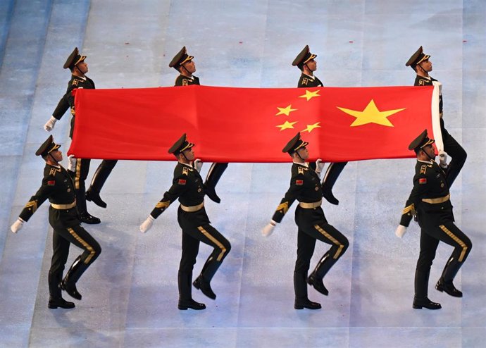 04 February 2022, China, Beijing: Chinese military personnel march with the Chinese national flag before being hoisted during the opening ceremony of the Beijing 2022 Winter Olympics at the Bird's Nest National Stadium. Photo: Robert Michael/dpa-Zentral