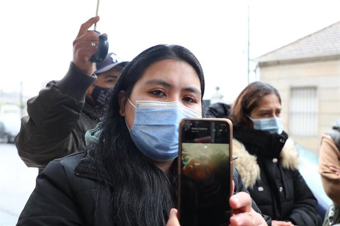 La mujer de uno de los marineros desaparecidos del pesquero 'Villa de Pintanxo', enseña su foto, a su llegada a Pesquerías Nores Marín.
