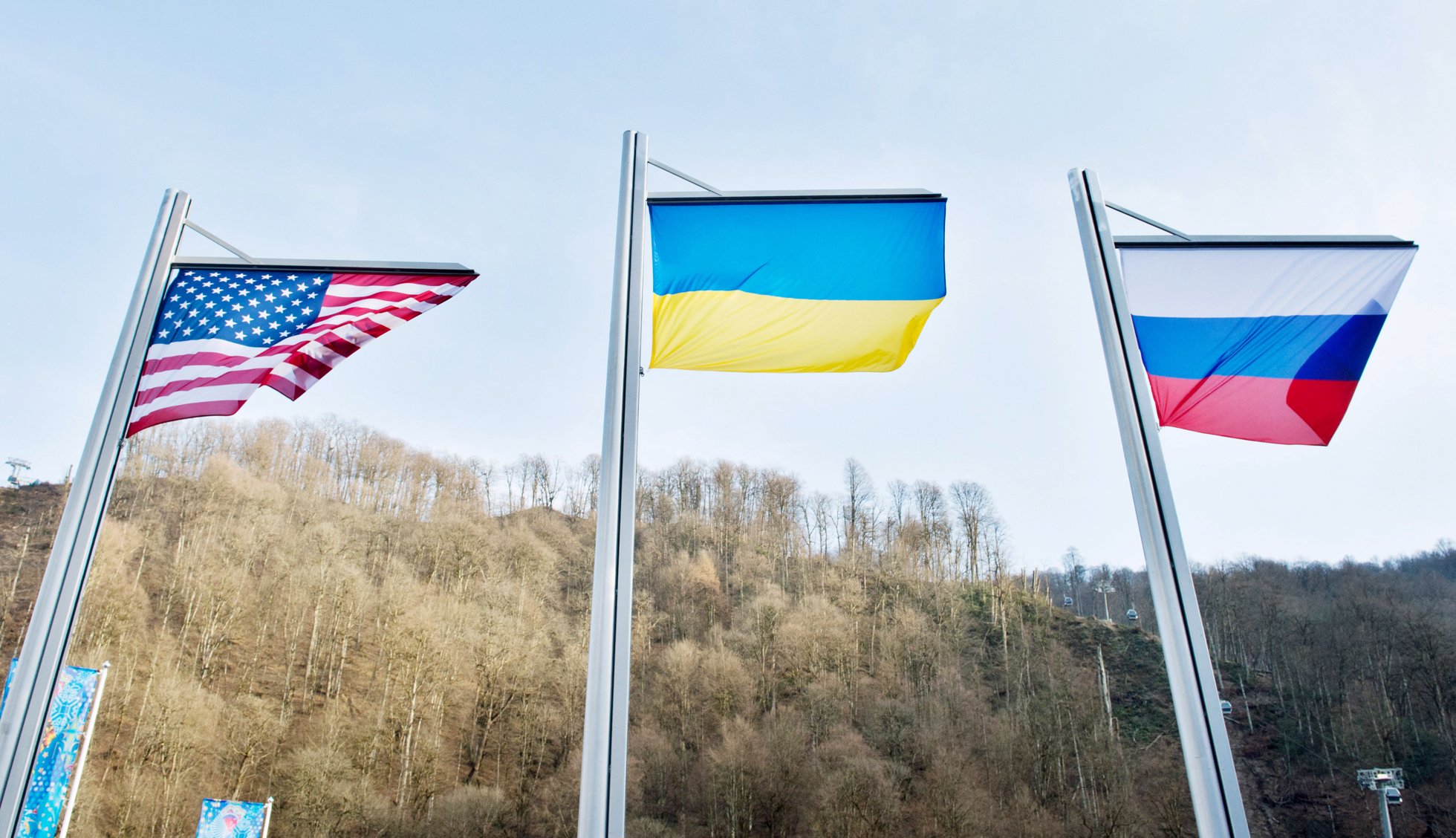 Flags of the USA, Ukraine and Russia wave on their masts